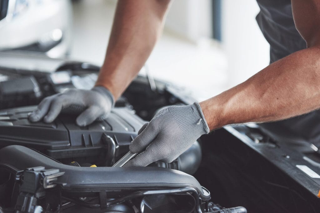 Auto mechanic working in garage. Repair service